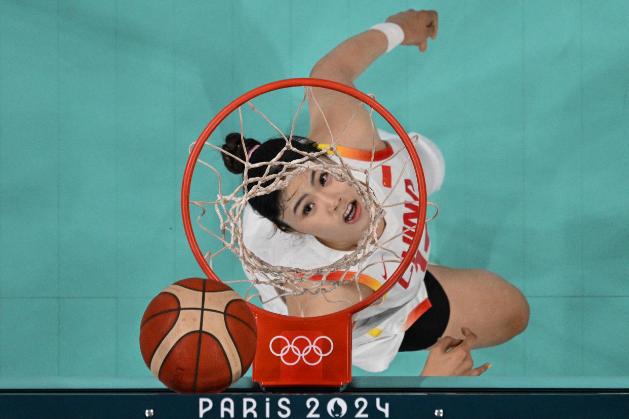 An overview shows China's #14 Li Yueru looking at the ball in the women's preliminary round group A basketball match between China and Serbia during the Paris 2024 Olympic Games at the Pierre-Mauroy stadium in Villeneuve-d'Ascq, northern France, on July 31, 2024. (Sameer al-Doumy/Pool via AFP via Getty Images)