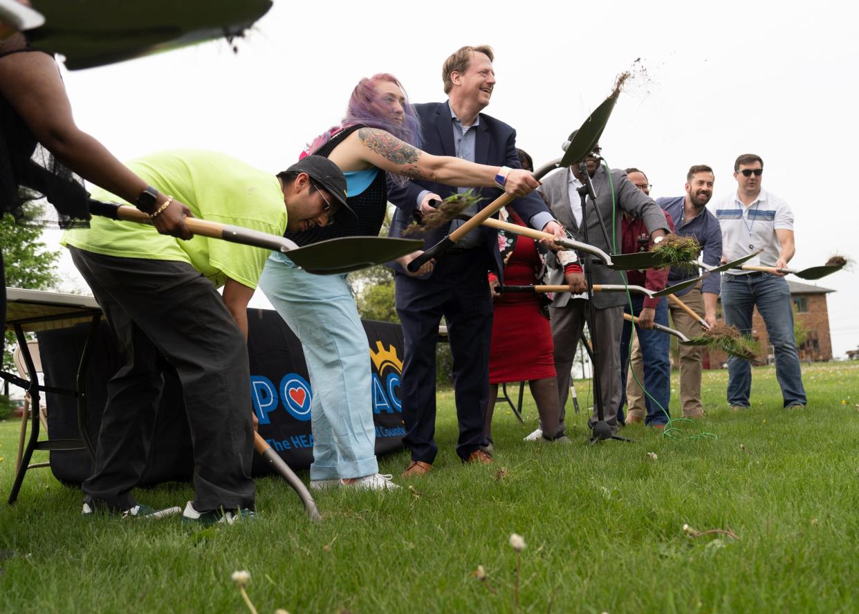 Marijayne Renny, who spearheaded plans for a new skateboard park in Pontiac, thrusts her shovel highest as she stands to the left of Pontiac Mayor Tim Greimel during groundbreaking for the facility on May 12, 2023.