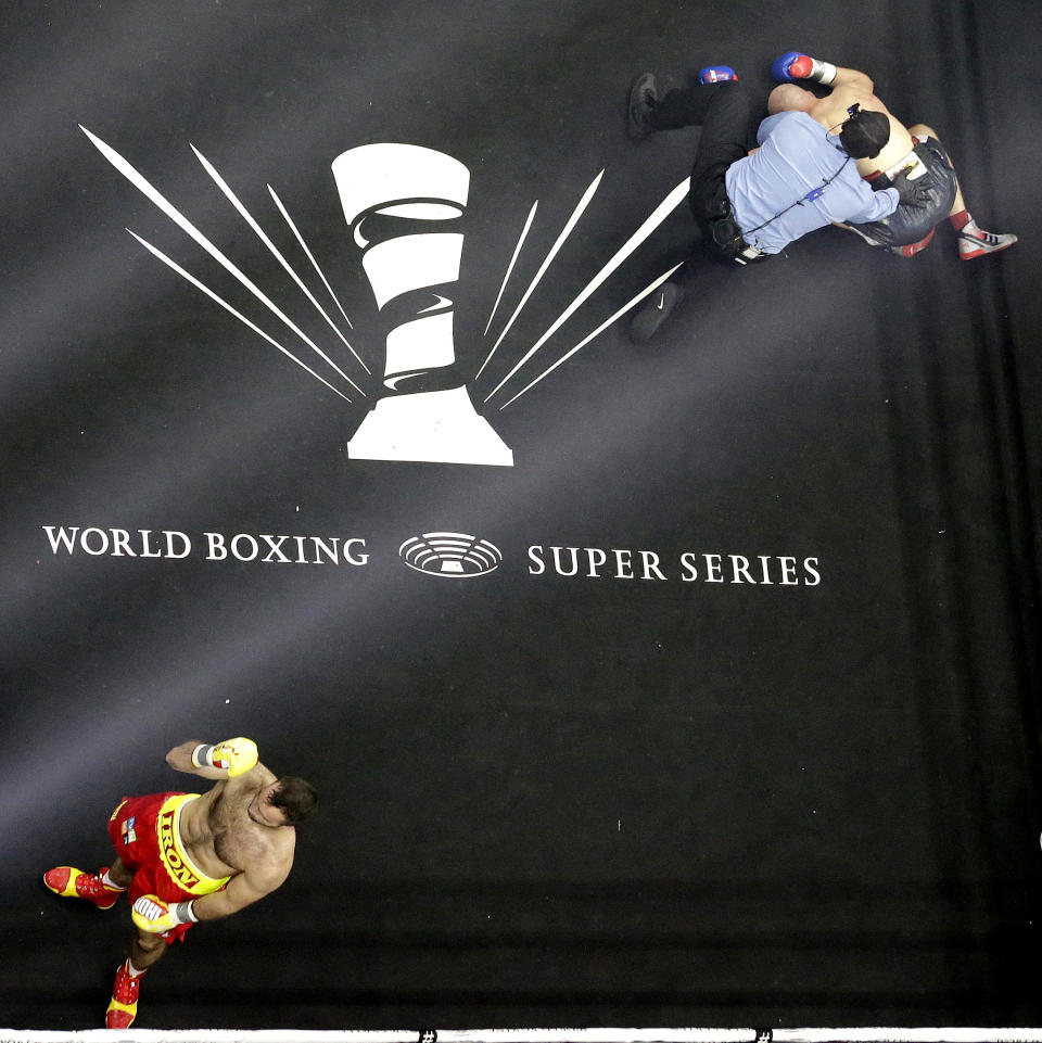Krzysztof Wlodarczyk, top right, lays on the canvas as referee Earl Brown checks on him moments after he was knocked out by Murat Gassiev in the third round of a cruiserweight bout, Saturday, Oct. 21, 2017, at Prudential Center in Newark, N.J. (AP Photo/Julio Cortez)
