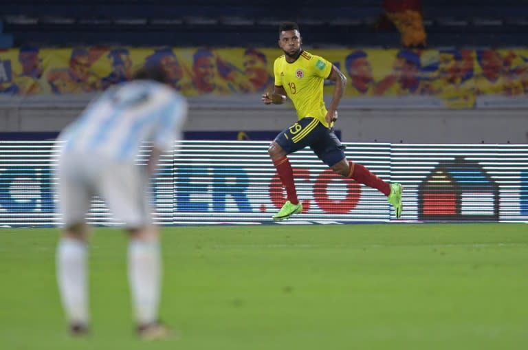 Colombia's Miguel Borja wheels away to celebrate his dramatic equalizer as Argentina captain Lionel Messi looks on