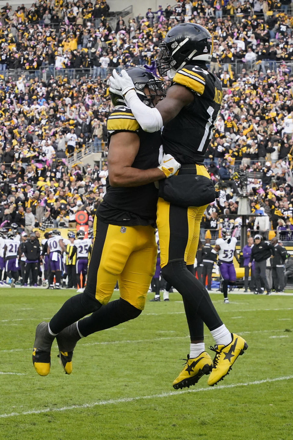Pittsburgh Steelers wide receiver George Pickens, right, celebrates a touchdown with Connor Heyward, left, in the second half of an NFL football game against the Baltimore Ravens, in Pittsburgh, Sunday, Oct. 8, 2023. (AP Photo/Gene J. Puskar)