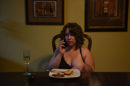 Lauren Hoffmann, 29, a college program manager, talks on the phone while nursing her son Micah at the dinner table in San Antonio, Texas, U.S., February 6, 2019. Hoffmann only had five and a half weeks of accrued paid time off from her job. "You're worried about this tiny little new life, you love it so fiercely," she said. "Having more time to feel like you're getting good at this ... I think that could only be a good thing." REUTERS/Callaghan O'Hare