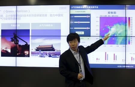 Meng Zhang, Chief Meteorologists of IBM Research in China, talks about graphics showing the company's smog forecasting system called the "Green Horizon", at its research office in Beijing, China, December 9, 2015. REUTERS/Jason Lee