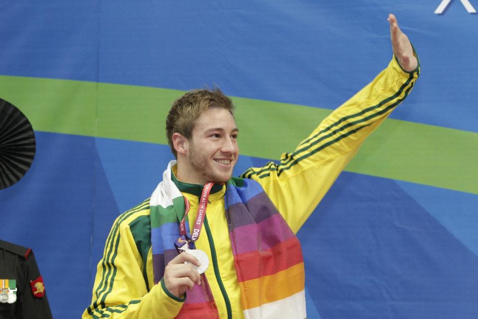 FILE - In this Wednesday, Oct. 13, 2010 file photo, Australia's Matthew Mitcham celebrates with his silver medal in the men's 10m platform diving event during the Commonwealth Games in New Delhi, India. Mitcham, a 2008 gold medalist in Beijing, is one of a tiny group of openly gay athletes expected to compete in London 2012. (AP Photo/Domenico Stinellis)