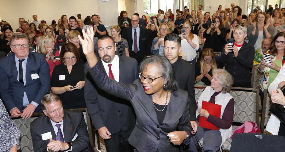 Anita Hill waves as she arrives for speech at the University of Utah Wednesday, Sept. 26, 2018, in Salt Lake City. Hill has been back in the spotlight since Christine Blasey Ford accused Supreme Court nominee Brett Kavanaugh of sexually assaulting her when the two were in high school. Hill's 1991 testimony against Clarence Thomas riveted the nation. Thomas was confirmed anyway, but the hearing ushered in a new awareness of sexual harassment. (AP Photo/Rick Bowmer)