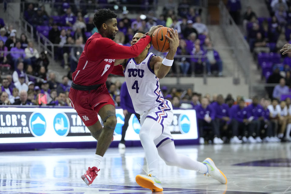 Houston guard Mylik Wilson (8) fouls TCU guard Jameer Nelson Jr. (4) during the first half of an NCAA college basketball game, Saturday, Jan. 13, 2024, in Fort Worth, Texas. (AP Photo/Julio Cortez)