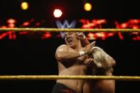 WWE wrestler Bin Wang of China headlocks his opponent Wesley Blake during a taping of the WWE's NXT show at Full Sail University in Winter Park, Florida, November 30, 2016. REUTERS/Scott Audette