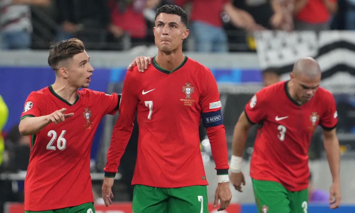 <span>Francisco Conceição, 21, tells Cristiano Ronaldo, 39, to get on with it.</span><span>Photograph: Masashi Hara/Getty Images</span>