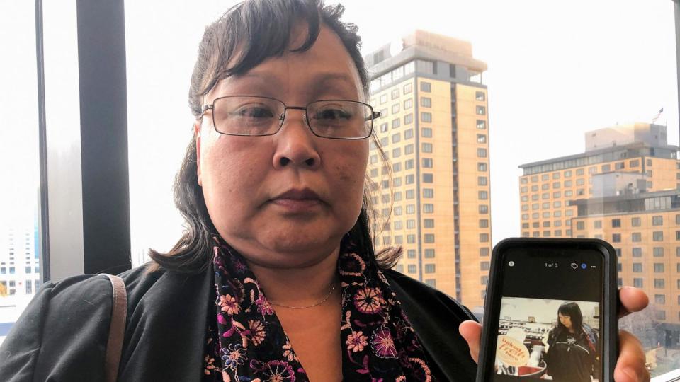 PHOTO: Rena Sapp, outside a courtroom, Oct. 21, 2019, in Anchorage, Alaska, shows a photo of her sister, Veronica Abouchuk, taken during a day out shopping in 2013. (Mark Thiessen/AP)