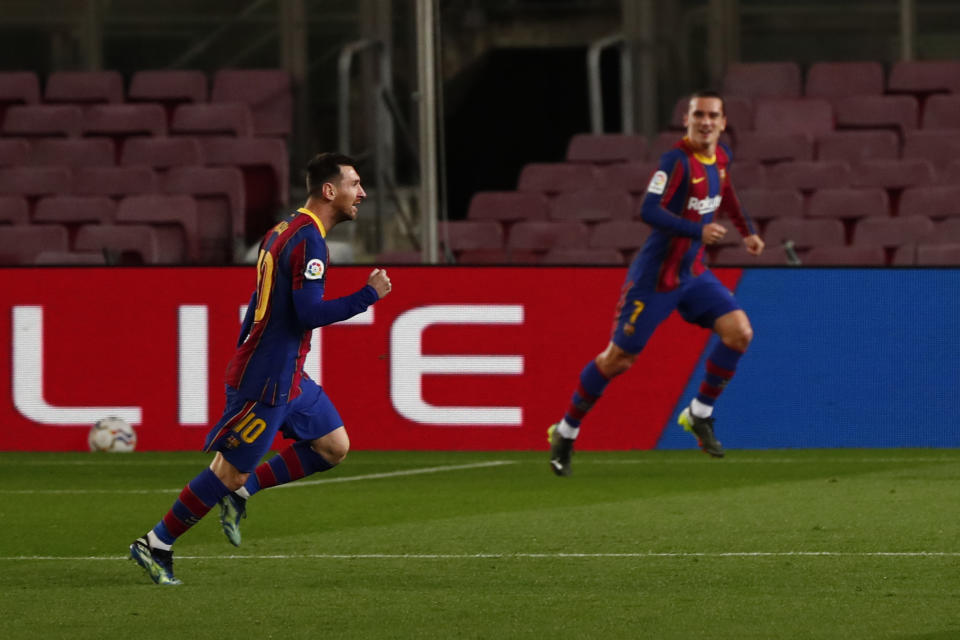 Barcelona's Lionel Messi, left, celebrates after scoring his side's opening goal during the Spanish La Liga soccer match between FC Barcelona and Athletic Bilbao at the Camp Nou stadium in Barcelona, Spain, Sunday, Jan. 31, 2021. (AP Photo/Joan Monfort)