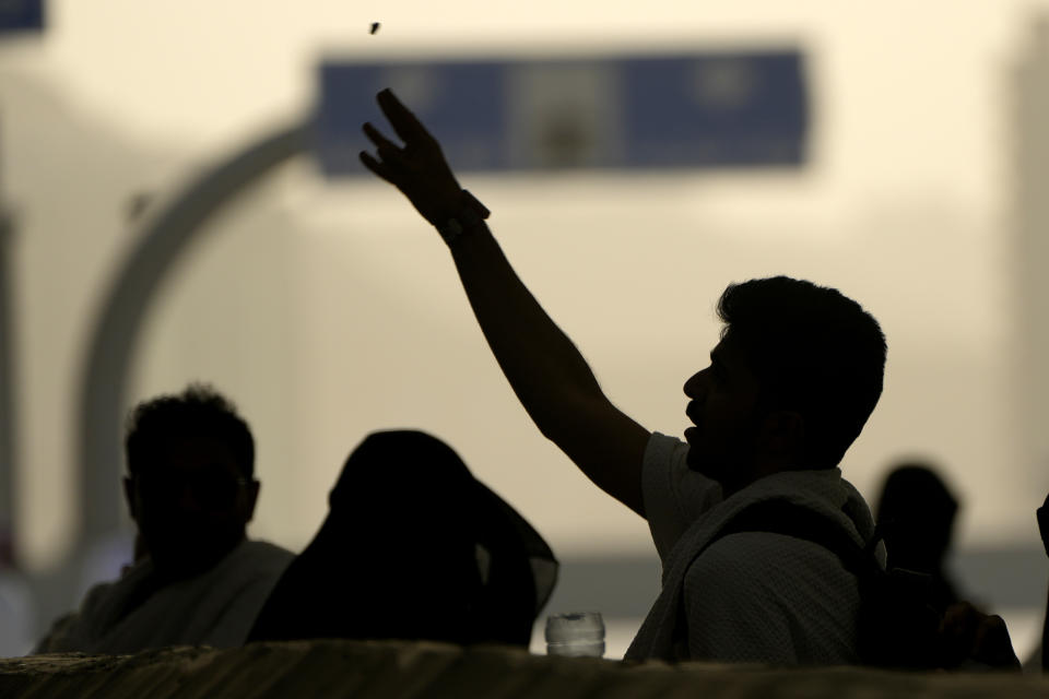 Pilgrims cast stones at a pillar in the symbolic stoning of the devil, the last rite of the annual Hajj pilgrimage, in Mina near the holly city of Mecca, Saudi Arabia, Wednesday, June 28, 2023. (AP Photo/Amr Nabil)