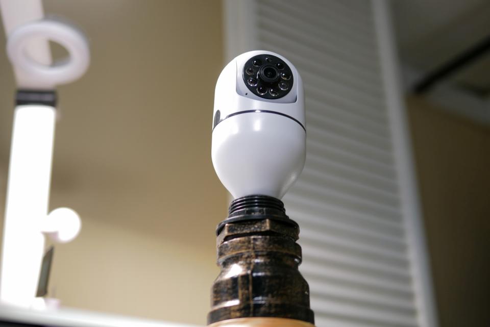 Owluck Security Camera Light Bulb connected to light bulb socket.