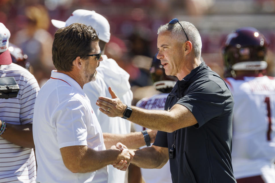 Virginia Tech head coach Brent Pry, left, greets Florida State head coach Mike Norvell prior to the kick off of their NCAA college football game, Saturday, Oct. 7, 2023, in Tallahassee, Fla. (AP Photo/Colin Hackley)