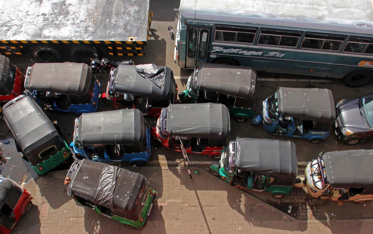 Vehicles wait in a queue to buy fuel in Colombo on Monday - AFP