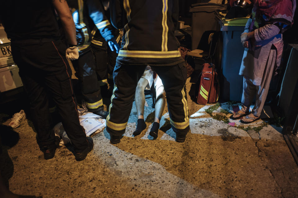 Rescue workers take care of an injured man after a violent brawl, in Paris suburb Villiers-le-Bel, Tuesday, June, 15, 2021. Police who patrol the tough suburbs north of the French capital say they feel that violence is ticking upward. Fights between rival groups are a long-standing problem in the Paris region's depressed neighborhoods, and police say they're increasingly bloody. (AP Photo/Lewis Joly)