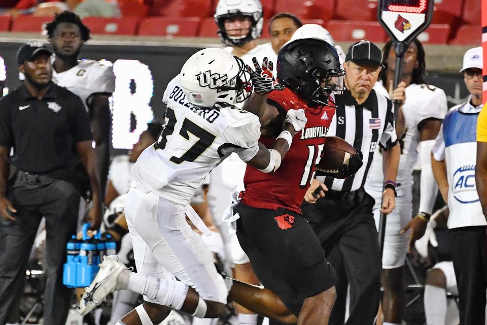 Central Florida defensive back Quadric Bullard (37) attempts to tackle Louisville running back Jalen Mitchell (15) during the second half of an NCAA college football game in Louisville, Ky., Friday, Sept. 17, 2021. (AP Photo/Timothy D. Easley)