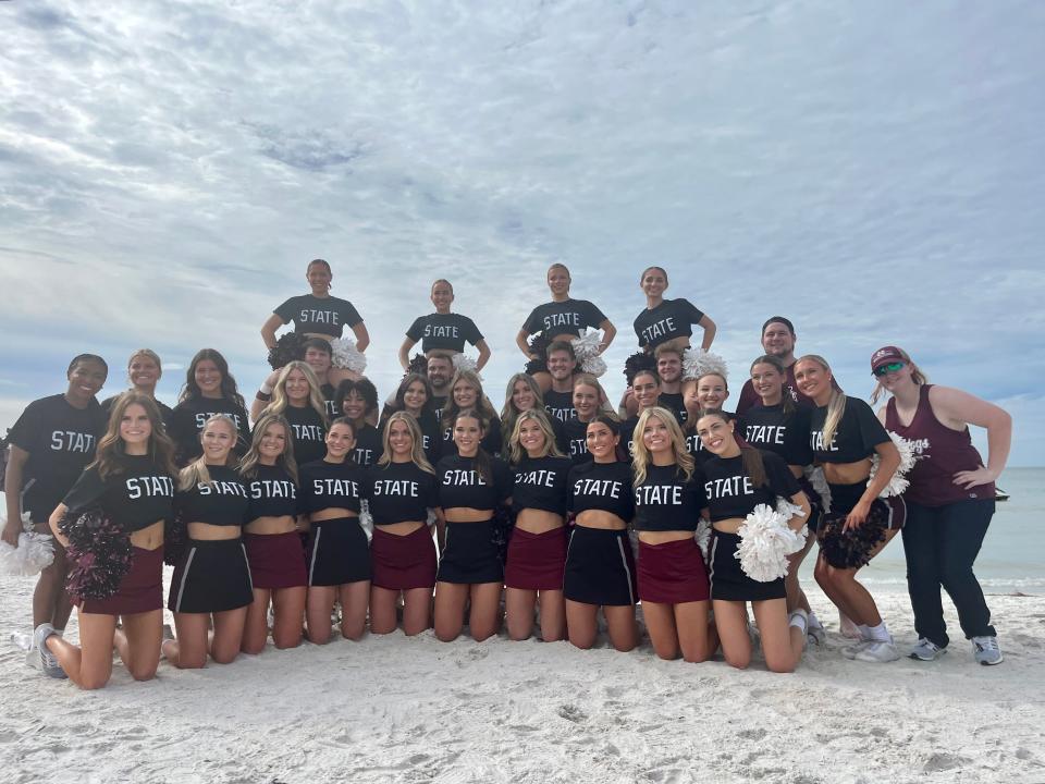 Mississippi State's spirit squad gathers for a photo during ReliaQuest Bowl beach day. The team was sporting shirts honoring former MSU coach Mike Leach who died on Dec. 12, 2022.