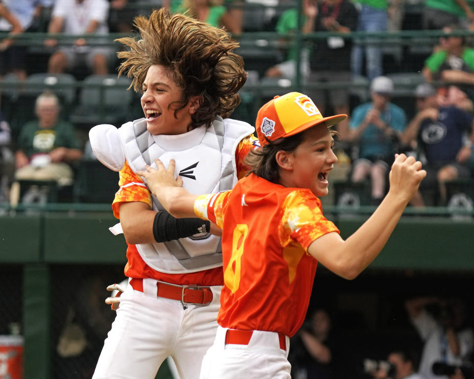 Needville, Texas, catcher DJ Jablonski, left, and starting pitcher Easton Benge (8) celebrate after getting the final out in the bottom of the ninth inning to win a baseball game against Seattle at the Little League World Series in South Williamsport, Pa., Wednesday, Aug. 23, 2023. (AP Photo/Gene J. Puskar)