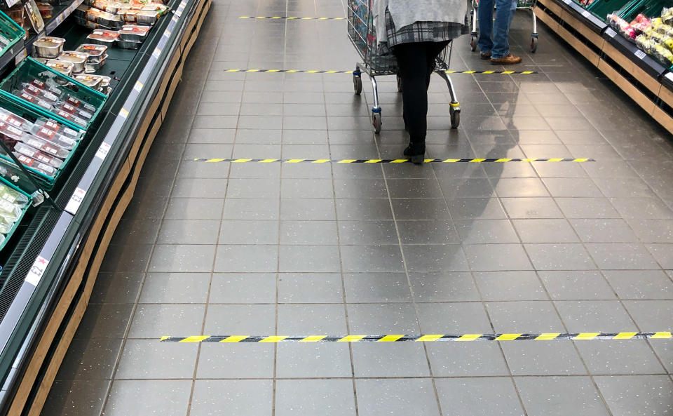 Tape marks out 2 metre sections on the floor to implement social distancing measures at a Tesco store in Peterborough, after Prime Minister Boris Johnson has put the UK in lockdown to help curb the spread of the coronavirus.