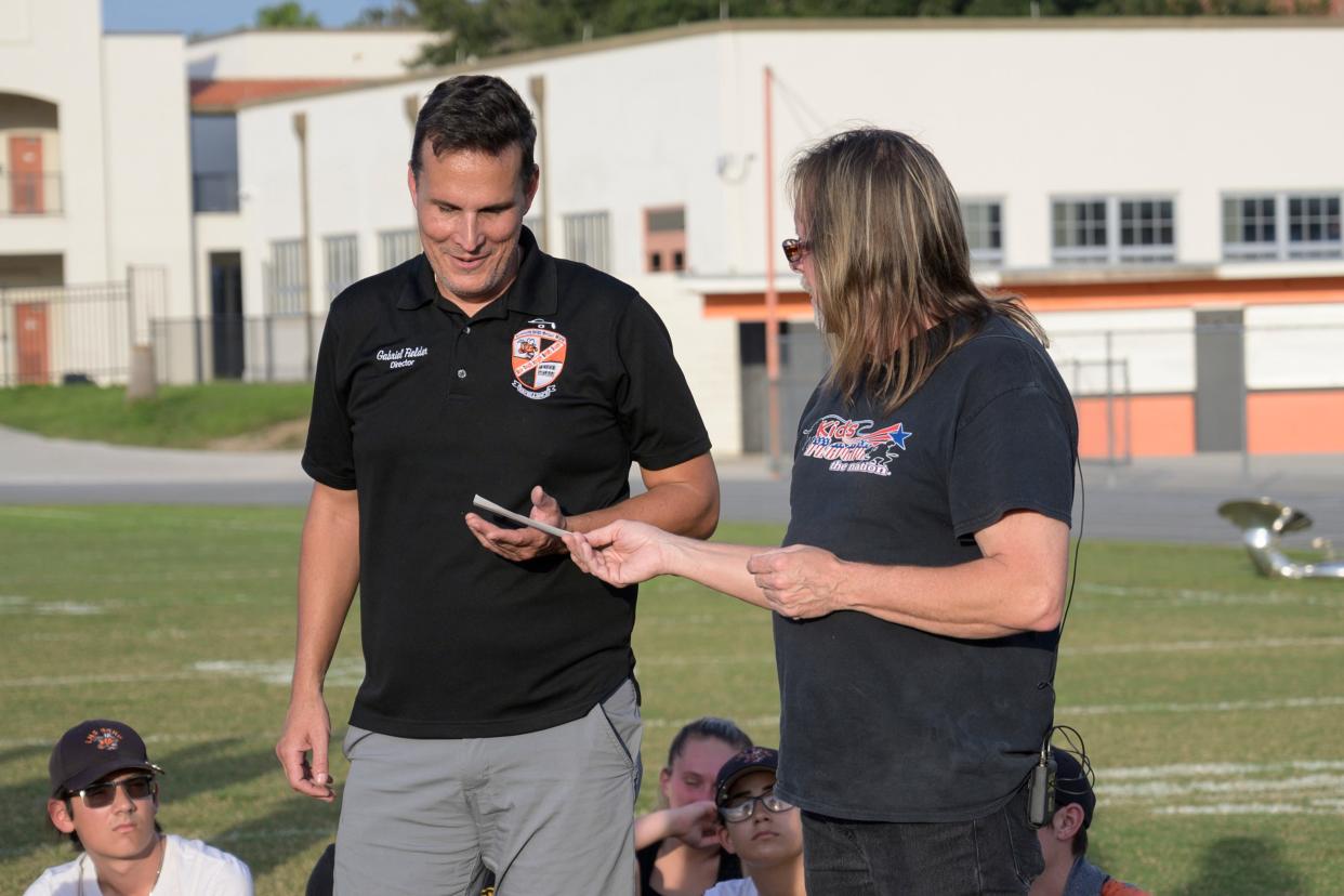 LHS band director Gabriel Fielder, left, has been accused of running a secret society.