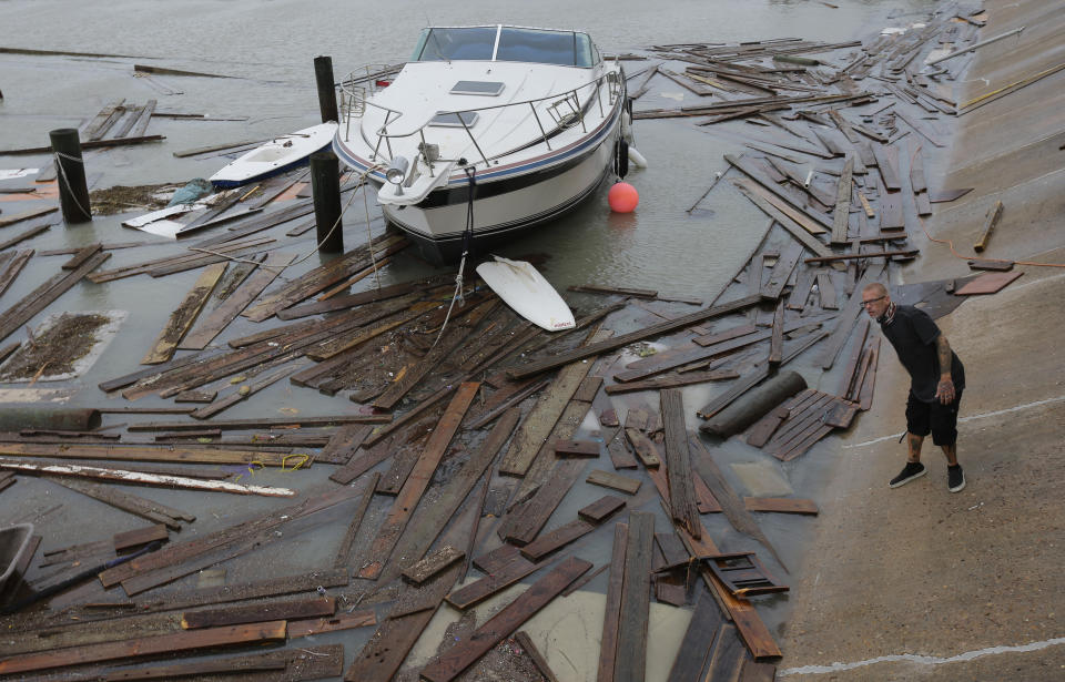 Shawn Pugsley surveys the damage to a private marina after it was hit by Hurricane Hanna, Sunday, July 26, 2020, in Corpus Christi,Texas. Nolan's boat and about 30 others were lost or damaged in the storm. (AP Photo/Eric Gay)