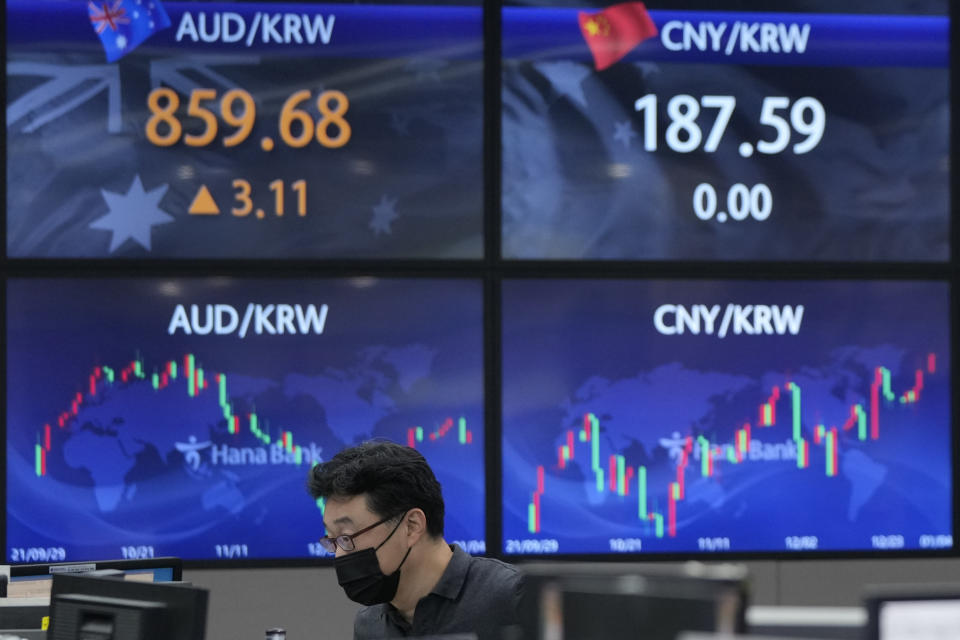 A currency trader watches monitors at the foreign exchange dealing room of the KEB Hana Bank headquarters in Seoul, South Korea, Tuesday, Jan. 4, 2022. Asian shares were mixed Tuesday, as worries in the region about the coronavirus omicron variant tempered market optimism set off by a rally on Wall Street. (AP Photo/Ahn Young-joon)
