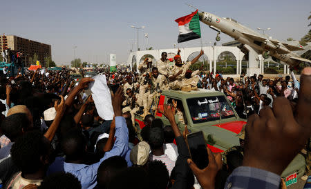 Sudanese soldiers are seen on their vehicles as they move with a military convoy outside the defense ministry compound in Khartoum, Sudan, April 25, 2019. REUTERS/Umit Bektas