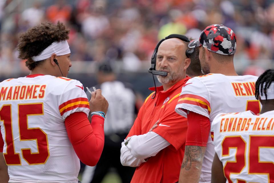 Kansas City Chiefs quarterbacks coach Matt Nagy, center, talks with quarterback Patrick Mahomes, left, and Chad Henne during the first half of an NFL preseason football game against the Chicago Bears Saturday, Aug. 13, 2022, in Chicago.