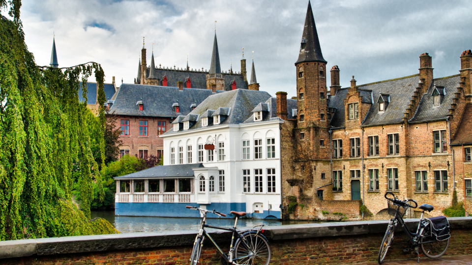 Two bikes propped up against a bridge in Ghent