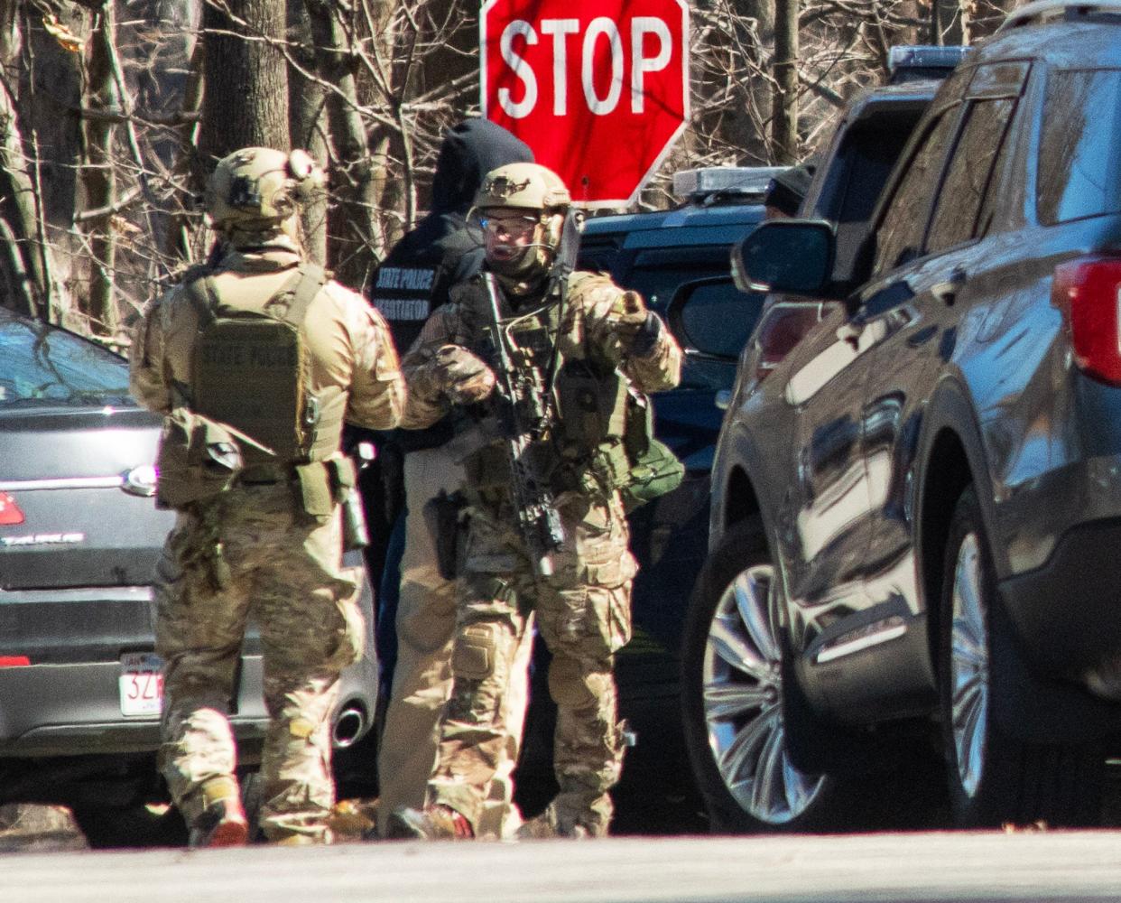 Members of a state police tactical unit gather int he area of Route 101 and Willard Road in Ashburnham Thursday morning. There was a standoff with a man who refused to exit his vehicle.
