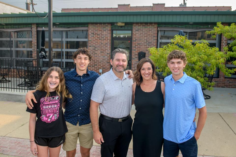 The Gruden family, from left, Gibby, 12, Owen, 16, Luke, Lynzie and Brady, 18, stand outside their new restaurant Whiskey Taco, at 507 Court St. in Pekin, the former location of the West Dublin Pub.
