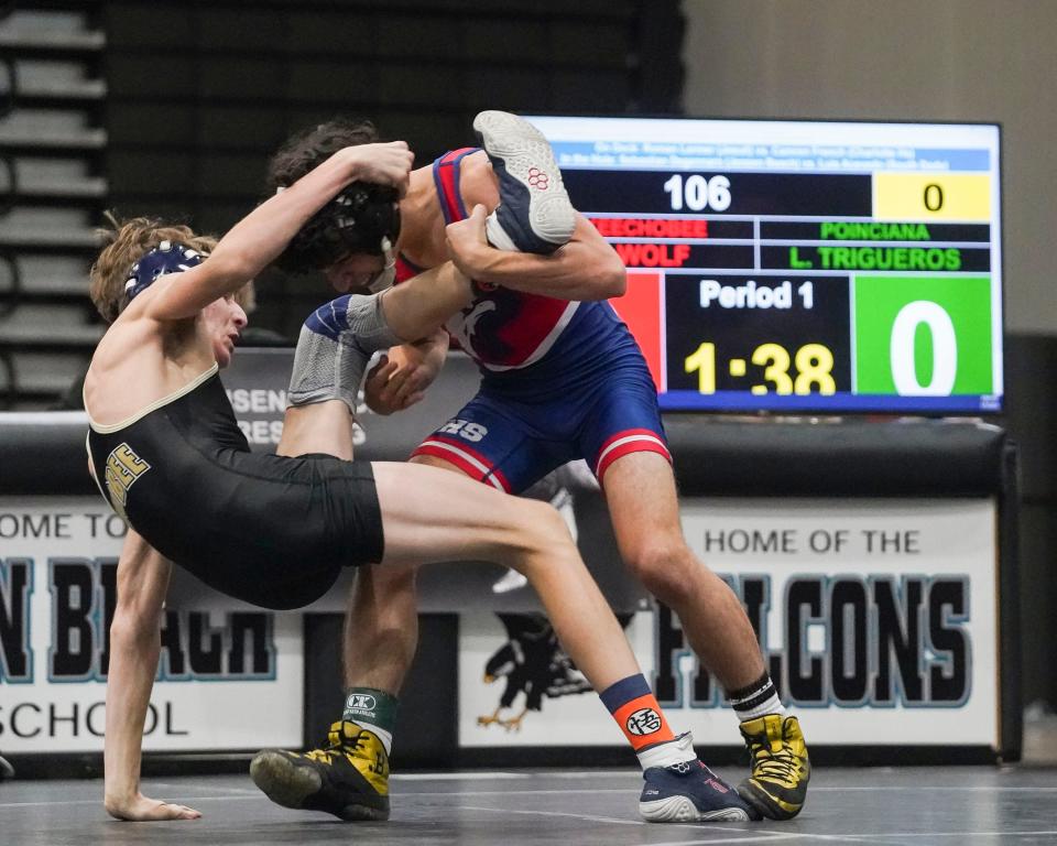 Poinciana's Landon Trigueros (right) wrestles Okeechobee's Clayton Wolf in the 106 pound match during the Cradle Cancer Invitational wrestling tournament on Saturday, Jan. 7, 2023, at Jensen Beach High School.