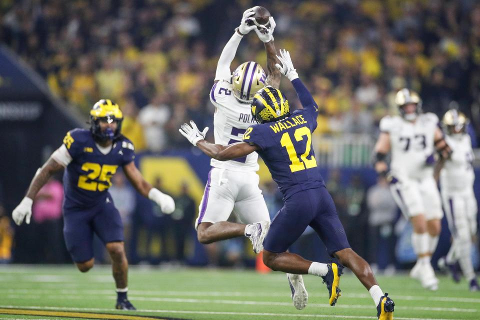 Washington wide receiver Ja’Lynn Polk makes a catch against Michigan defensive back Josh Wallace during the first half of the national championship game at NRG Stadium in Houston, Texas on Monday, Jan. 8, 2024.