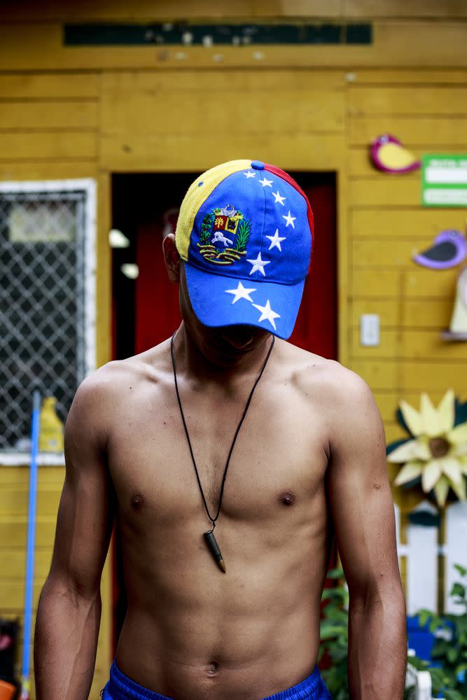 A Venezuelan man participating in the various anti-government protests in Managua on June 27. An AK-47 bullet hangs from his neck.
