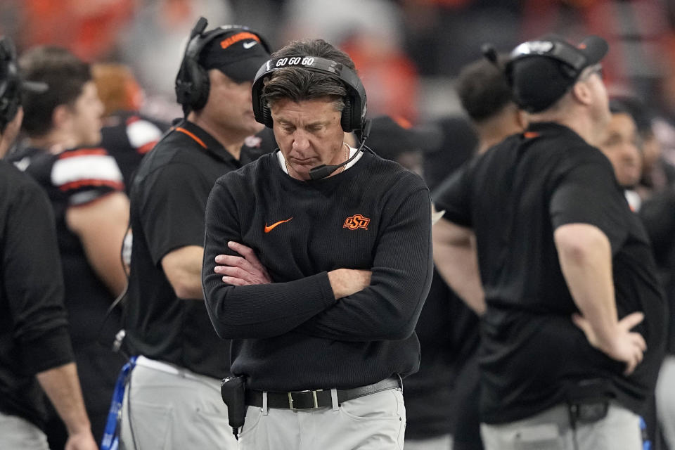 Oklahoma State head coach Mike Gundy walks along the sideline during the second half of the Big 12 Conference championship NCAA college football game against Texas in Arlington, Texas, Saturday, Dec. 2, 2023. (AP Photo/Tony Gutierrez)