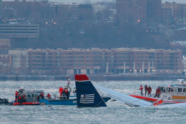 Mario Tama/Getty Rescue workers in boats assist a US Airways plane floating in the water after crashing into the Hudson River in the afternoon on January 15, 2009 in New York City.