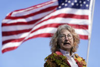 Shannon Ramsay, who heads the nonprofit group Trees Forever, speaks during a tree planting ceremony with school children, Friday, April 30, 2021, in Cedar Rapids, Iowa. A rare storm called a derecho plowed through the city of 130,000 last August with 140 mph winds and left behind a jumble of branches, downed powerlines and twisted signs. Now, city officials, businesses and nonprofit groups have teamed up with ambitious plans to somehow transform what is now a city of stumps back into the tree-covered Midwestern oasis along the Cedar River. (AP Photo/Charlie Neibergall)