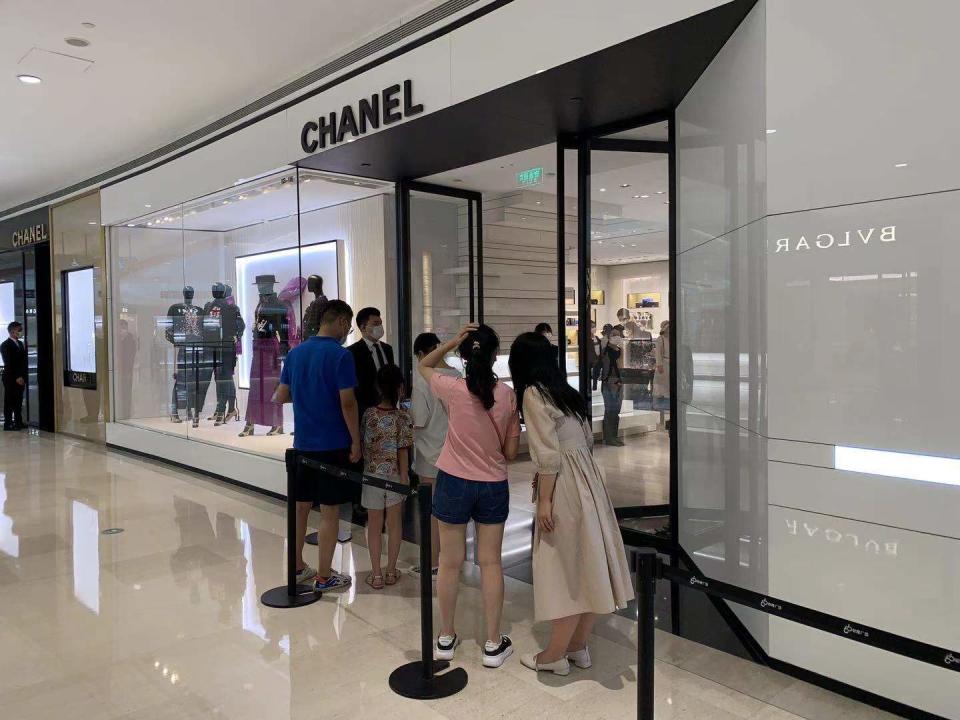 Shoppers queueing outside a Chanel store in Shanghai after a two-month lockdown. - Credit: Denni Hu/WWD