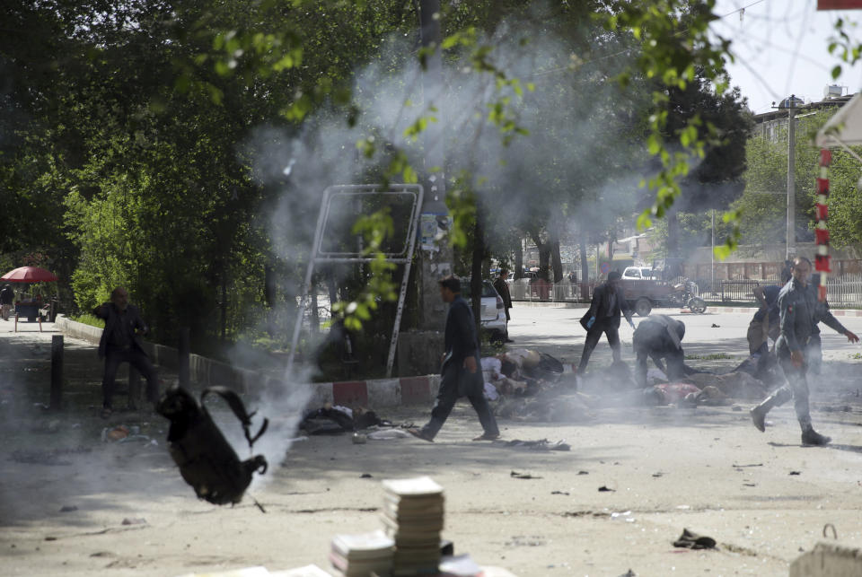 <p>Victims in double explosions lie on the ground in Kabul, Afghanistan, April 30, 2018. (Photo: Massoud Hossaini/AP) </p>