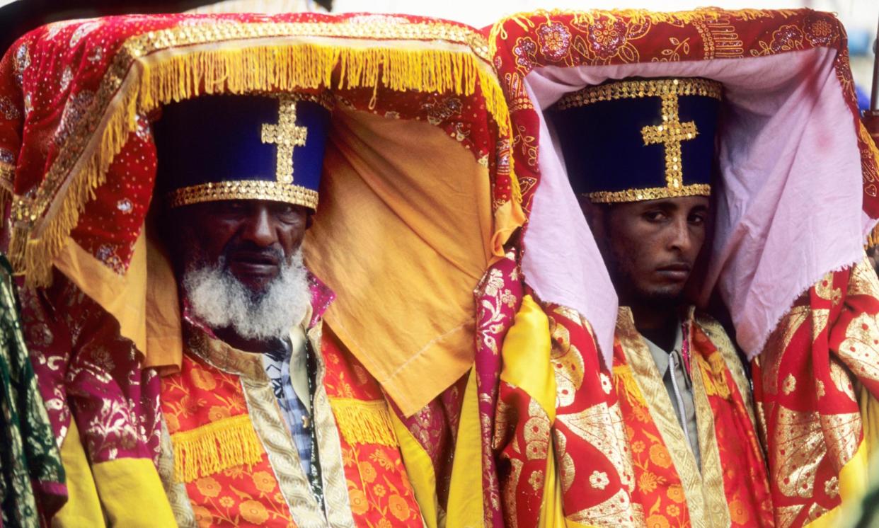 <span>Ethiopian priests at a religious festival carrying covered tabots on their heads.</span><span>Photograph: Age Fotostock/Alamy</span>