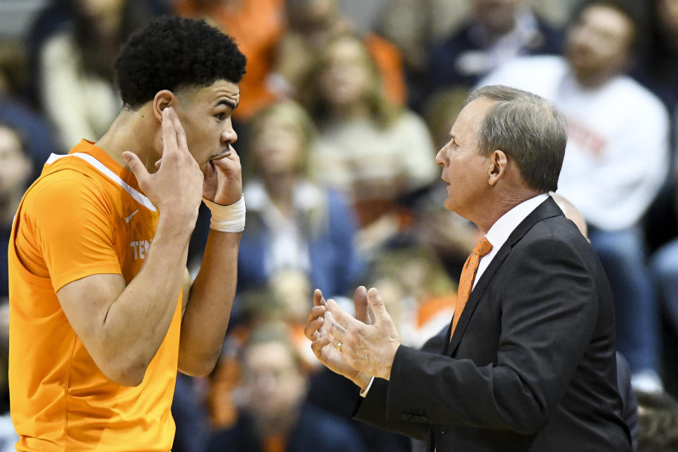 Tennessee forward Olivier Nkamhoua (21) talks with Tennessee head coach Rick Barnes during the first half of an NCAA college basketball game Saturday, Feb. 22, 2020, in Auburn, Ala. (AP Photo/Julie Bennett)