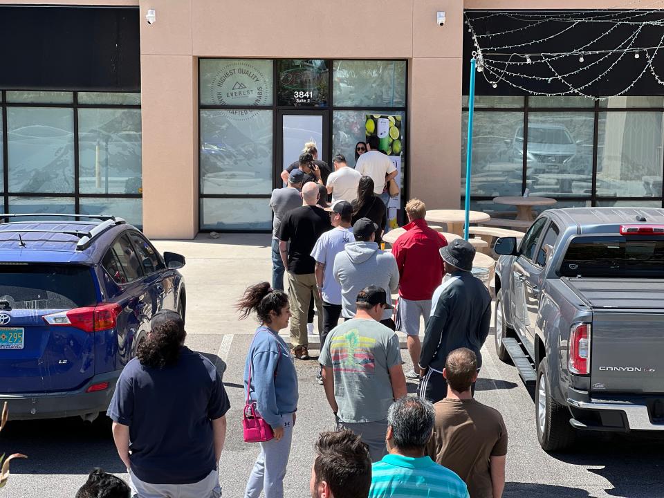 A line of customers wait outside cannabis dispensary Everest Apothecary in Las Cruces, N.M. on the first day recreational cannabis is legal for purchase on Friday, April 1, 2022.