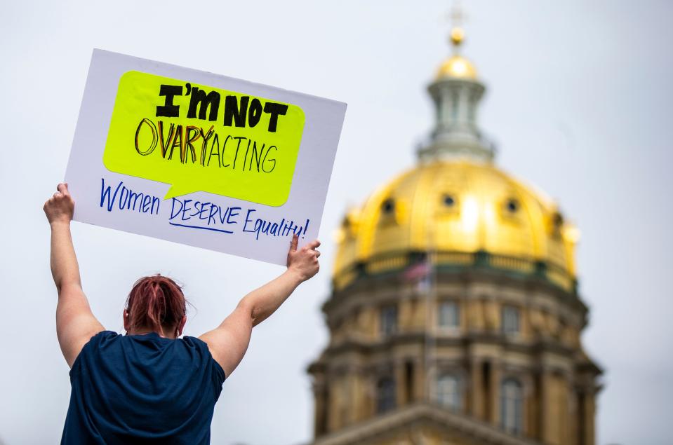 Lindsey Moseley, of Des Moines, holds a sign in protest during the 'Bans off our Bodies' abortion rights rally at the Iowa State Capitol Saturday, May 14, 2022 in Des Moines. 