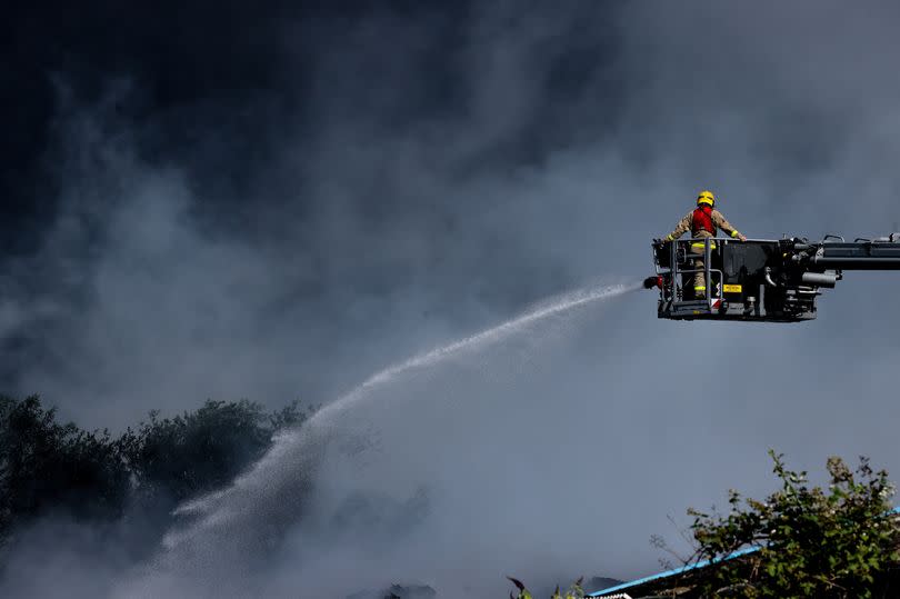 Fire fighters at the scene of a fire on an industrial estate on Wilson Road in Huyton today