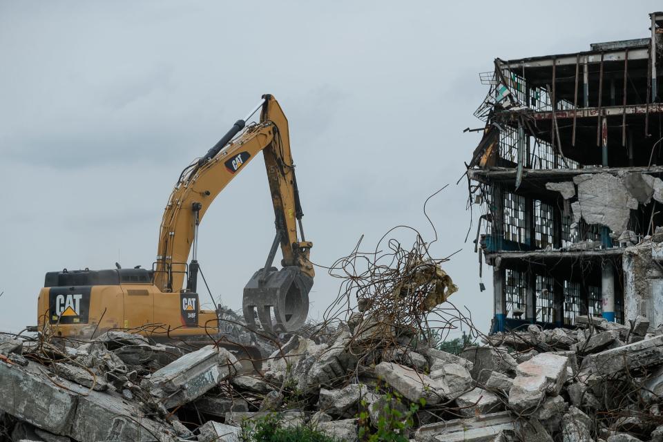 Crew members from Inner City Contracting work on demolition at the vacant Cadillac Stamping Plant in Detroit, June 2, 2021.