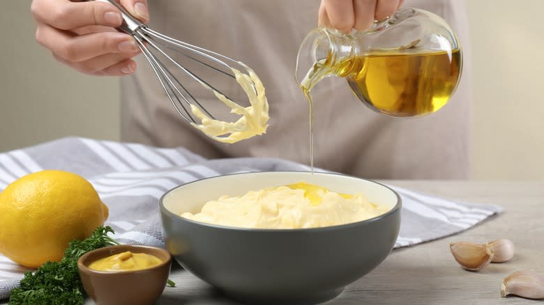 person making homemade mayonnaise