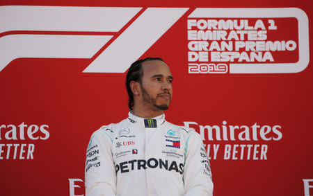 FILE PHOTO: Formula One F1 - Spanish Grand Prix - Circuit de Barcelona-Catalunya, Barcelona, Spain - May 12, 2019 First placed Mercedes' Lewis Hamilton on the podium. REUTERS/Jon Nazca