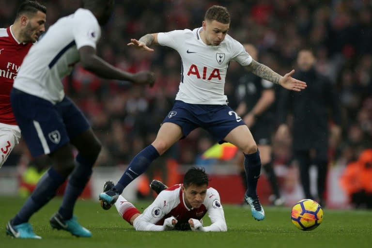 Tottenham Hotspur's Kieran Trippier jumps over Arsenal's Alexis Sanchez during their English Premier League match, at the Emirates Stadium in London, on November 18, 2017