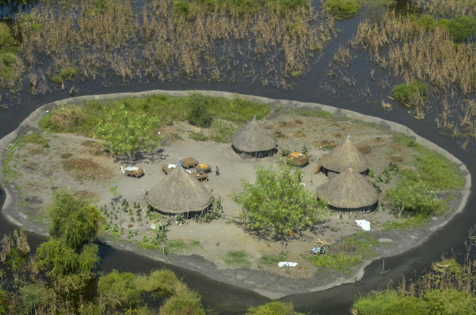 FILE - Thatched huts surrounded by floodwaters are seen from the air in Old Fangak county in Jonglei state, South Sudan on Nov. 27, 2020. A petition to stop the revival of the 118-year-old Jonglei Canal project in South Sudan, started by one of the country's top academics, is gaining traction in the country, with the waterway touted as a catastrophic environmental and social disaster for the country's Sudd wetlands. (AP Photo/Maura Ajak, File)