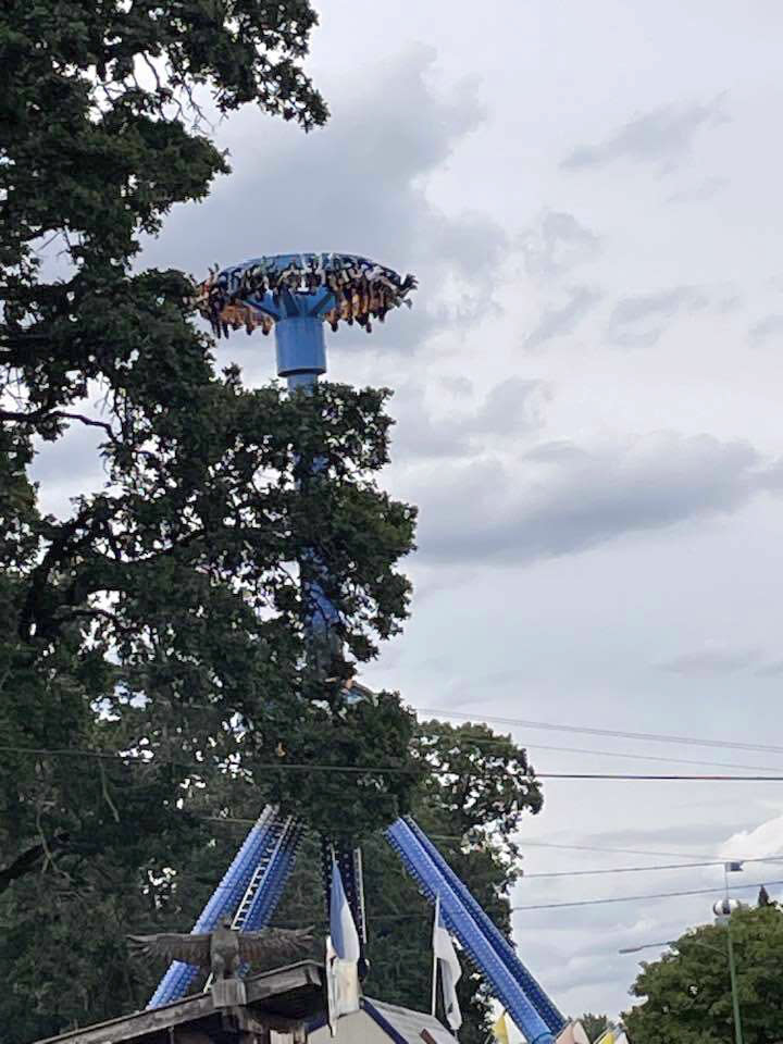 In this photo provided by Tieanna Joseph Cade, an amusement park ride is shown stuck with 30 people trapped upside down in Portland, Ore., on Friday, June 14, 2024. Portland Fire and Rescue said Friday on the social media site X that firefighters worked with engineers at Oaks Park to manually lower the ride. All riders were being evacuated and medically evaluated, it said. (Tieanna Joseph Cade via AP)